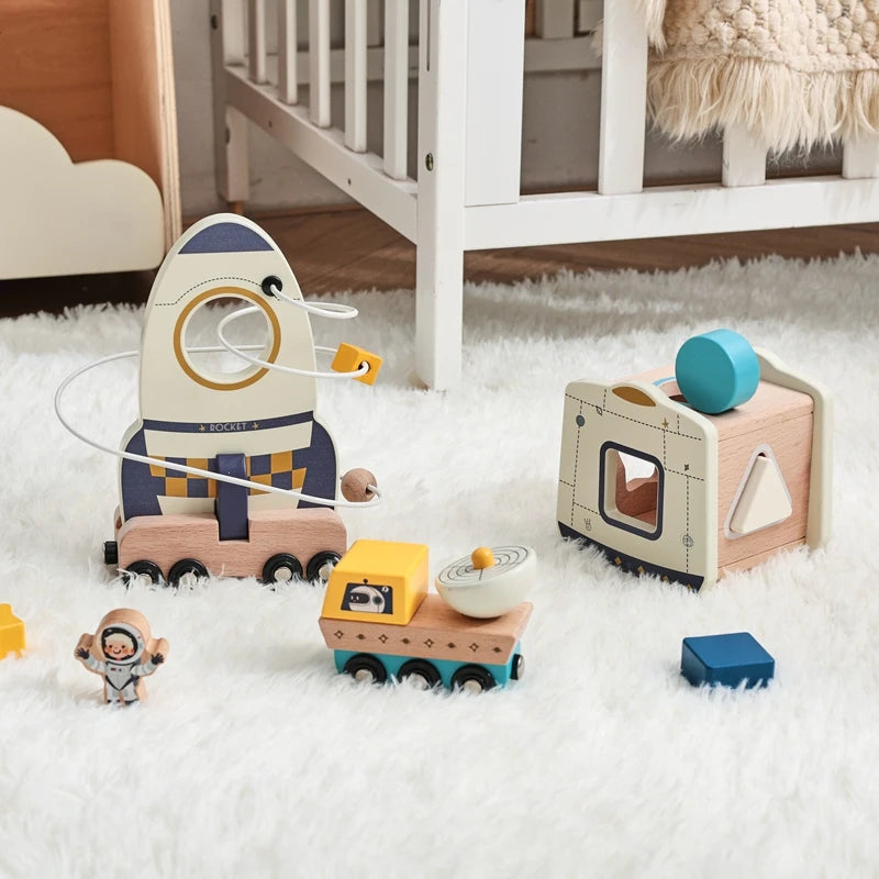 Wooden toys including a rocket and geometric shape sorter on a fluffy white carpet.