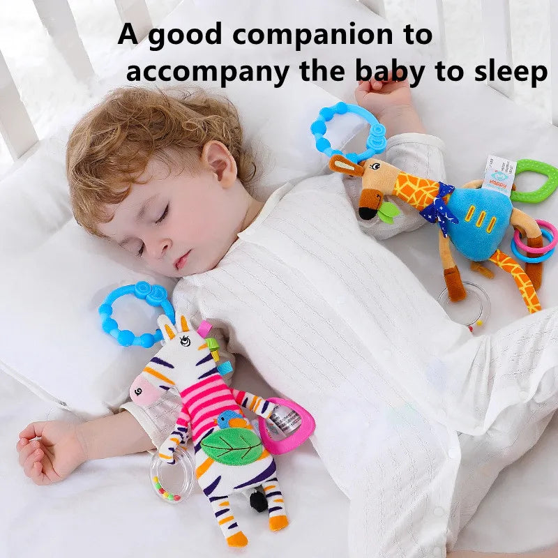 Child sleeping with colorful baby toys in a crib