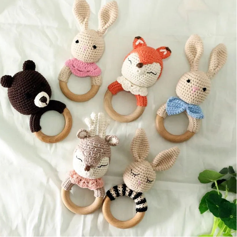 Set of crochet animal rattle toys on a white background