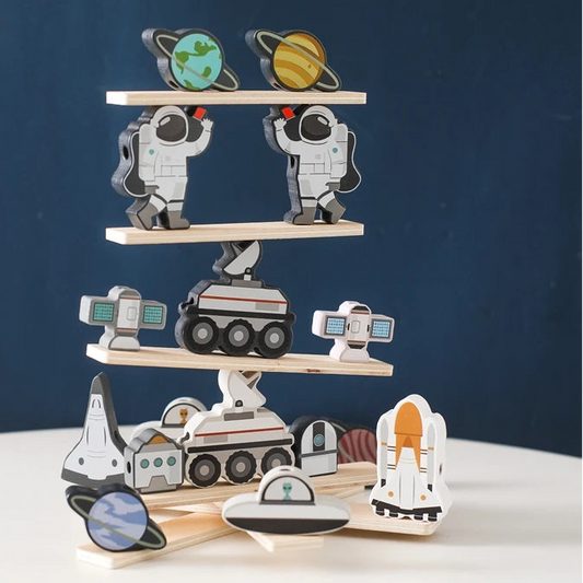 Wooden toy set with space-themed figures on a white surface against a dark blue background.
